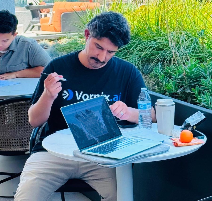Mustafa working through a client question at his laptop.